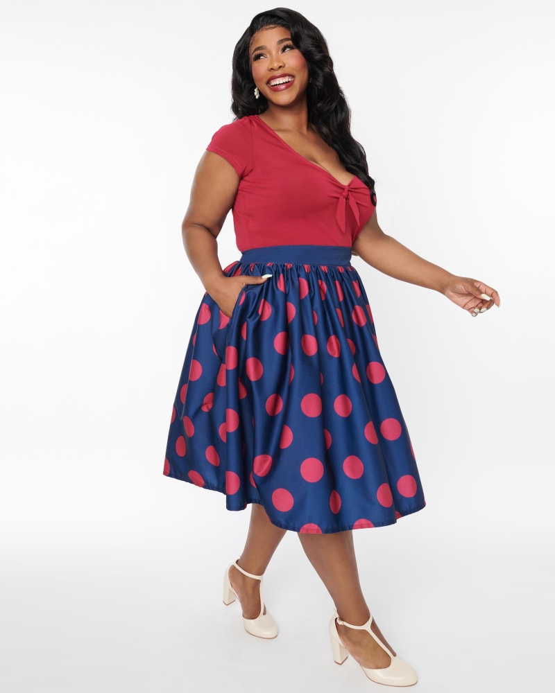 Front of a model wearing a size L Unique Vintage Navy & Berry Polka Dot Gellar Swing Skirt in Navy & Burgundy Polka Dot by Unique Vintage. | dia_product_style_image_id:316913